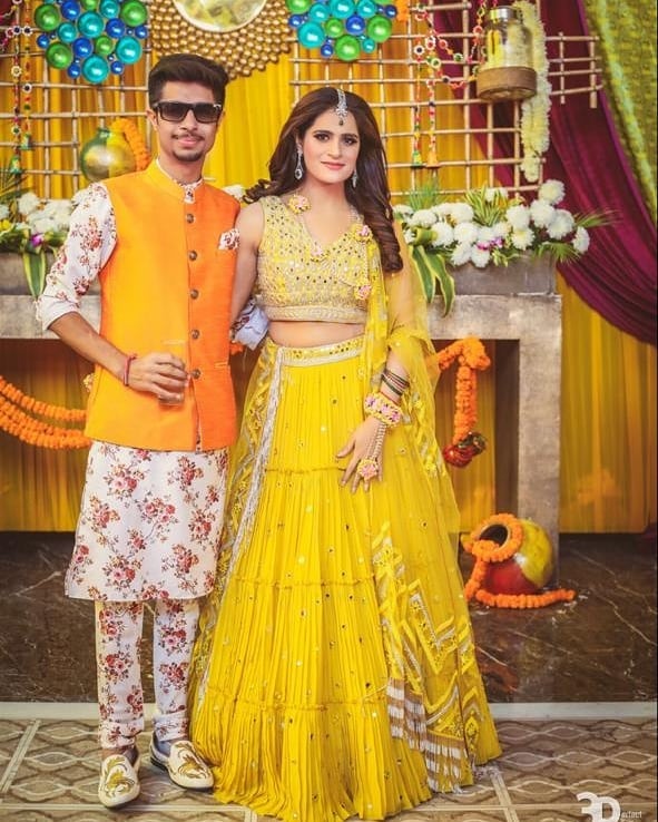 coordinating yellow and orange haldi outfits for couple