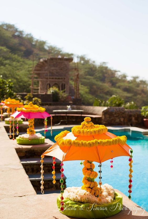 poolside haldi decoration with lamps and flowers