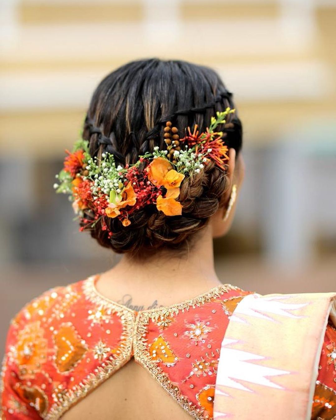 South Indian floral bun hairstyles for saree - beautiful reception bridal hairstyle