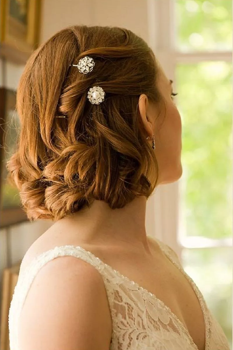 Stylish bride with classic wedding hairstyle and makeup in white gown with  open neckline, posing looking down 36616482 Stock Photo at Vecteezy