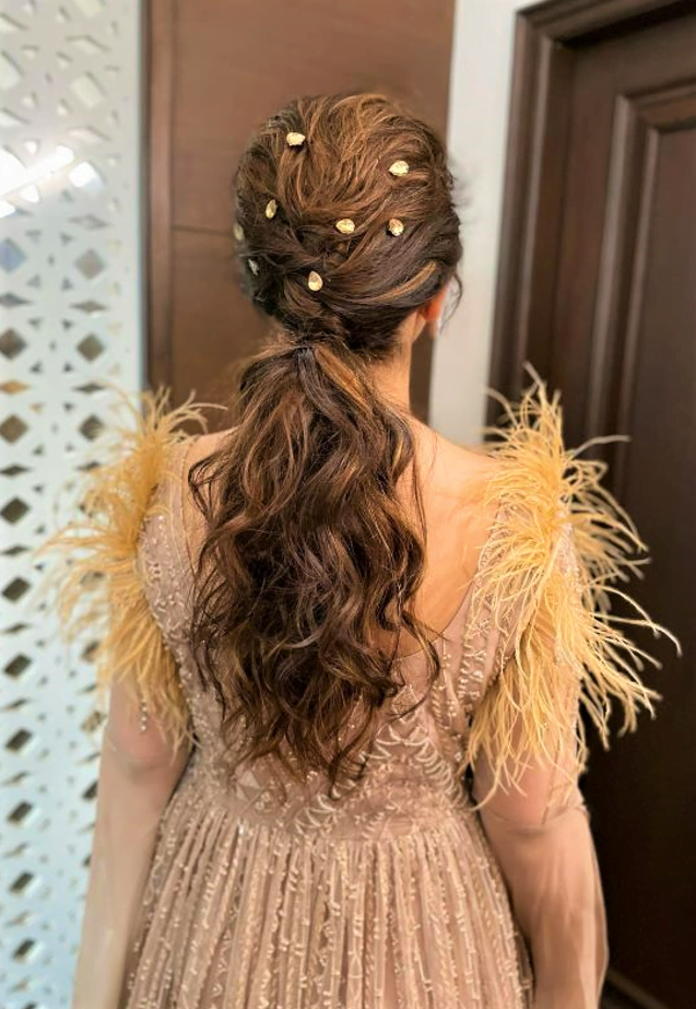 messy ponytail hairstyle for gown for reception and engagement 