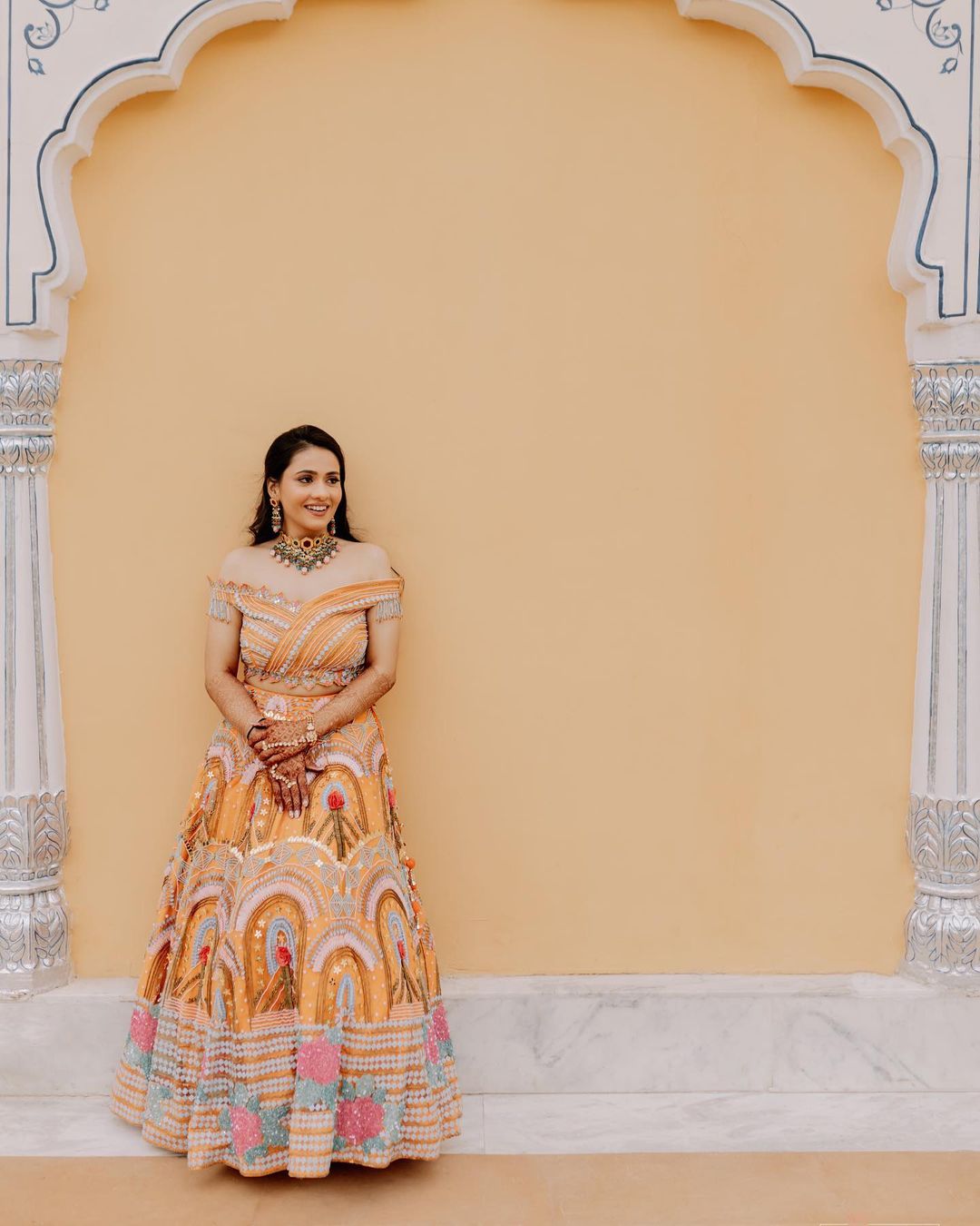 bride wearing yellow off-shoulder lehenga choli without dupatta