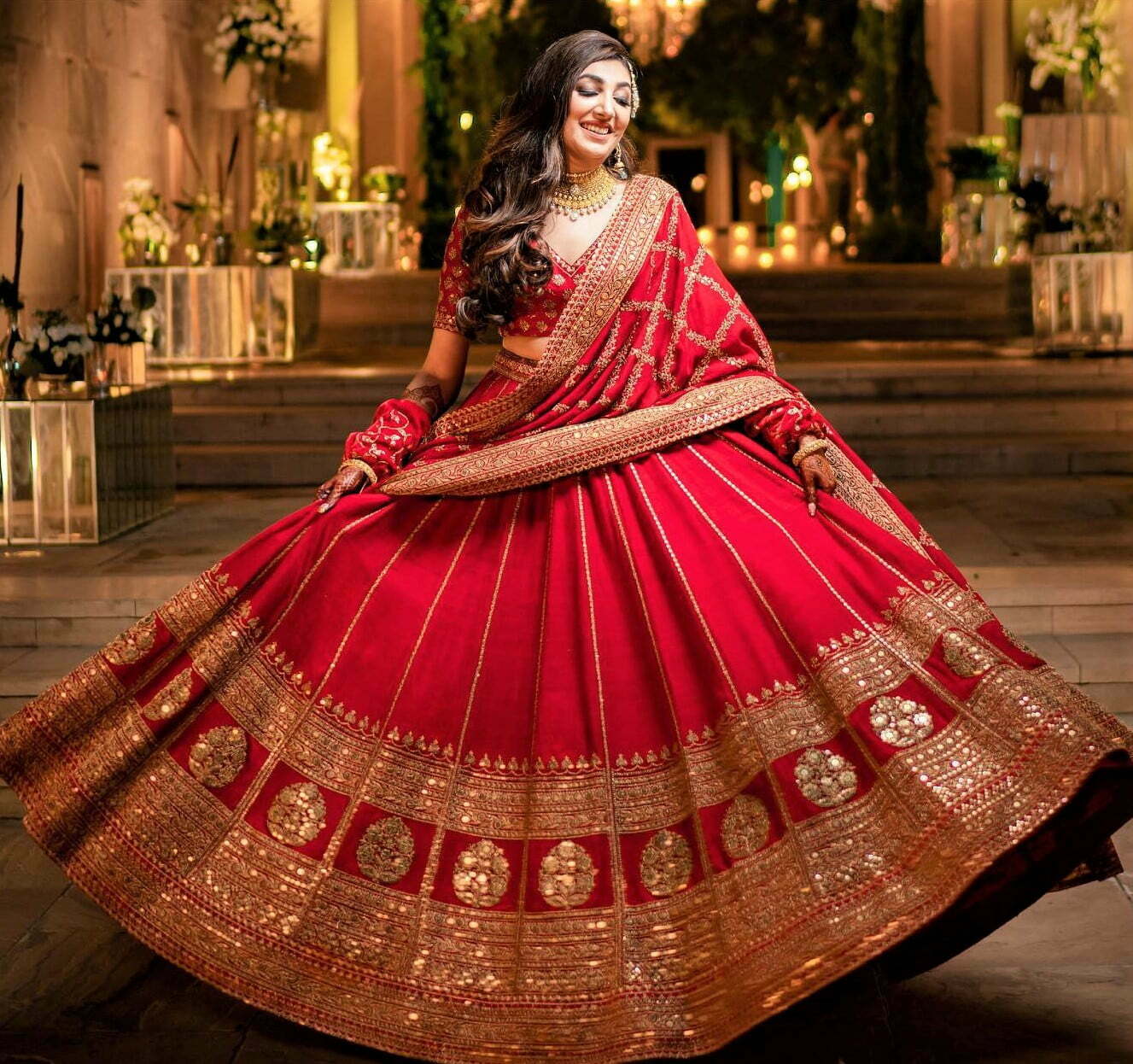 bride in Sabyasachi red and golden lehenga