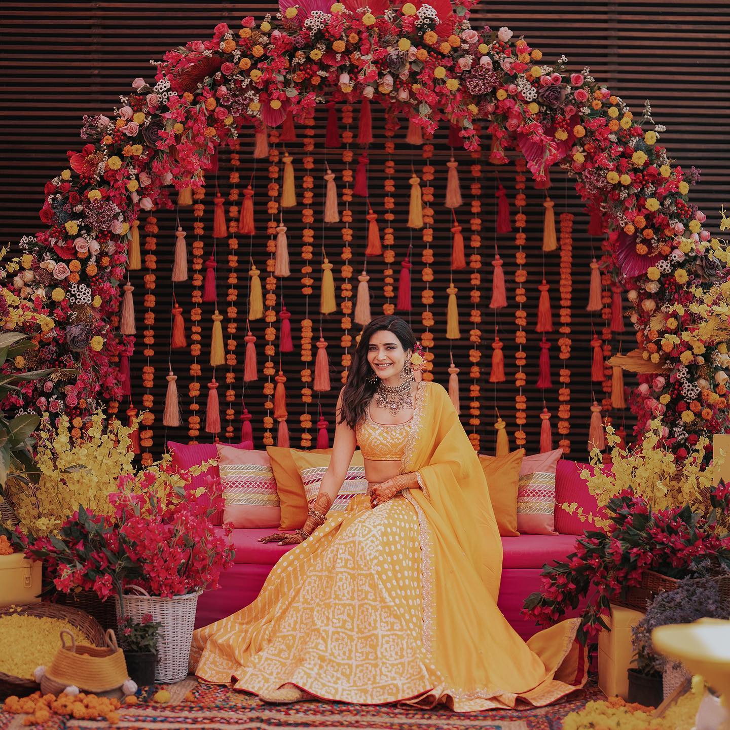 haldi background decoration with tassels and flowers for bride