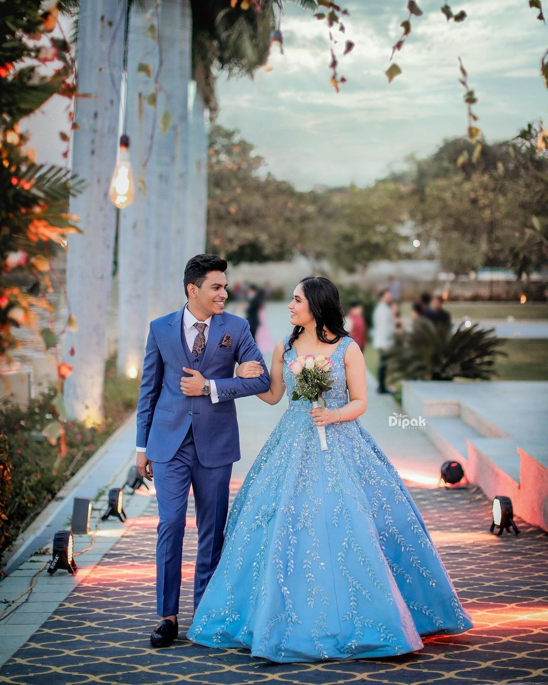 bride and groom in blue engagement dresses