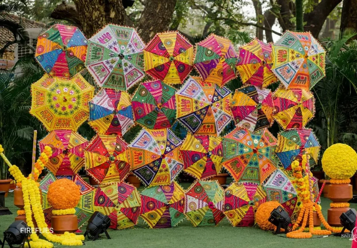 colourful and quirky umbrella backdrop for haldi