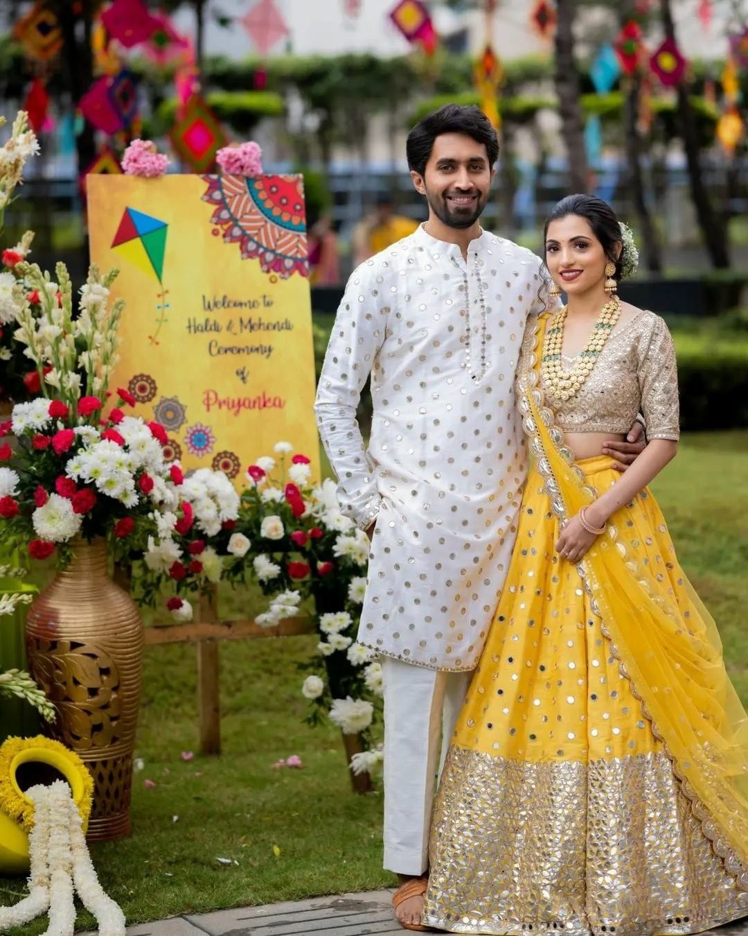 couple wearing white and yellow coordinating outfits on haldi