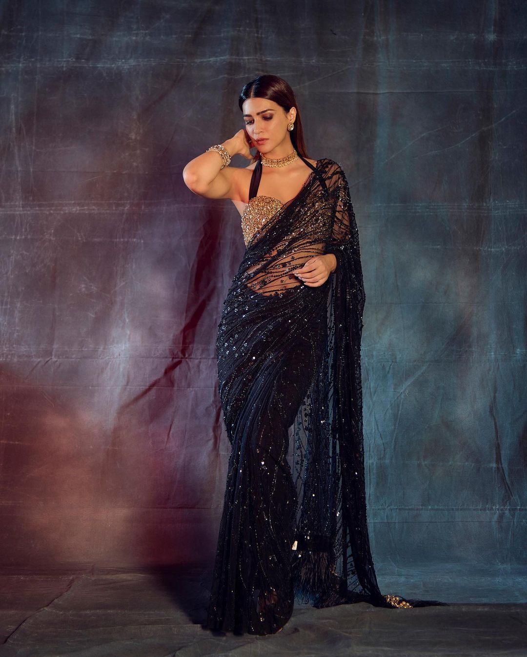 fancy black saree with golden blouse