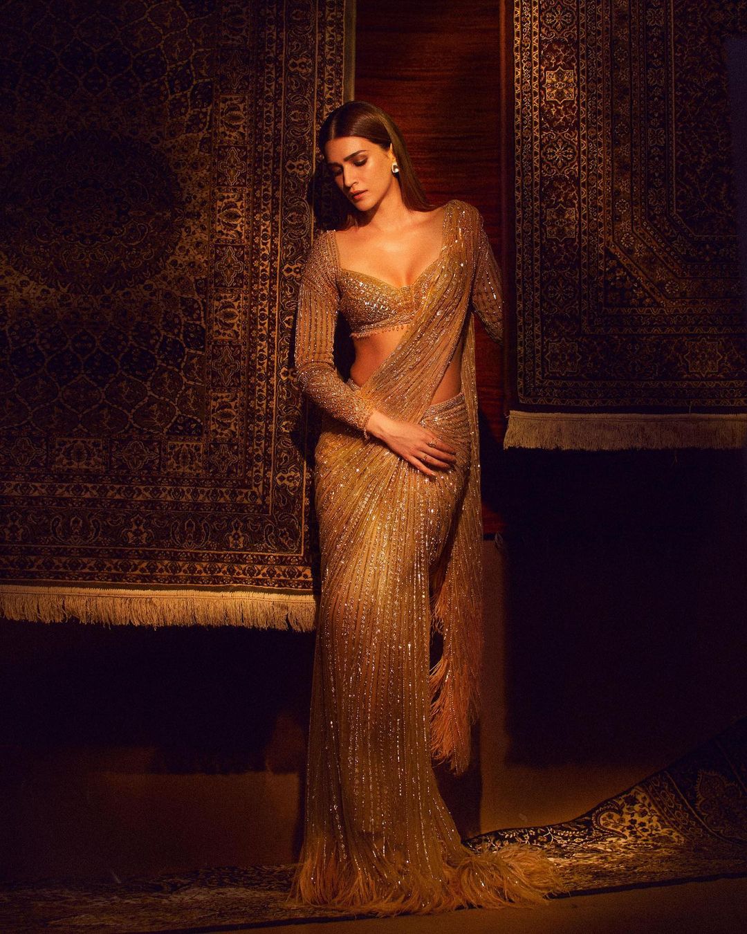 designer gold saree with feather trail