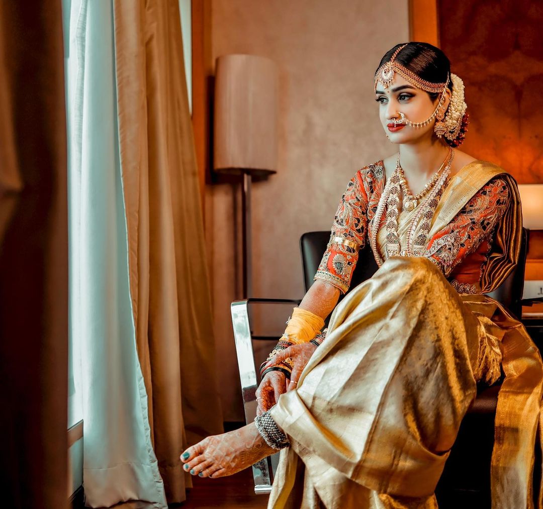 south indian wedding saree look featuring golden saree with contrast blouse