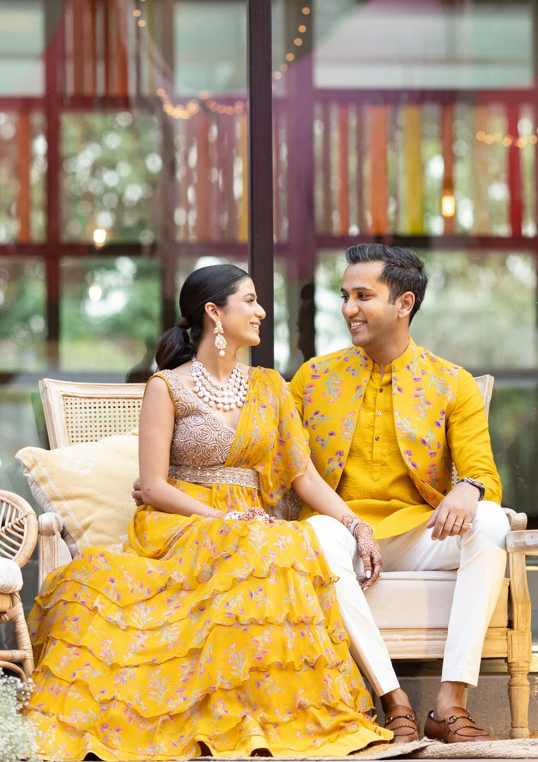 couple wearing yellow and white matching outfits on haldi