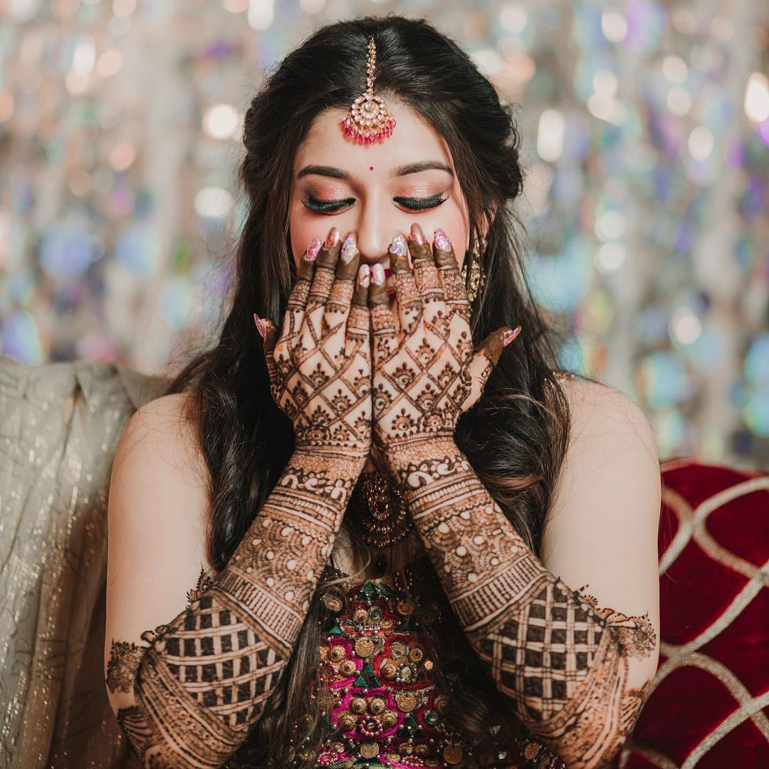 solo bridal mehndi pic with hands covering face