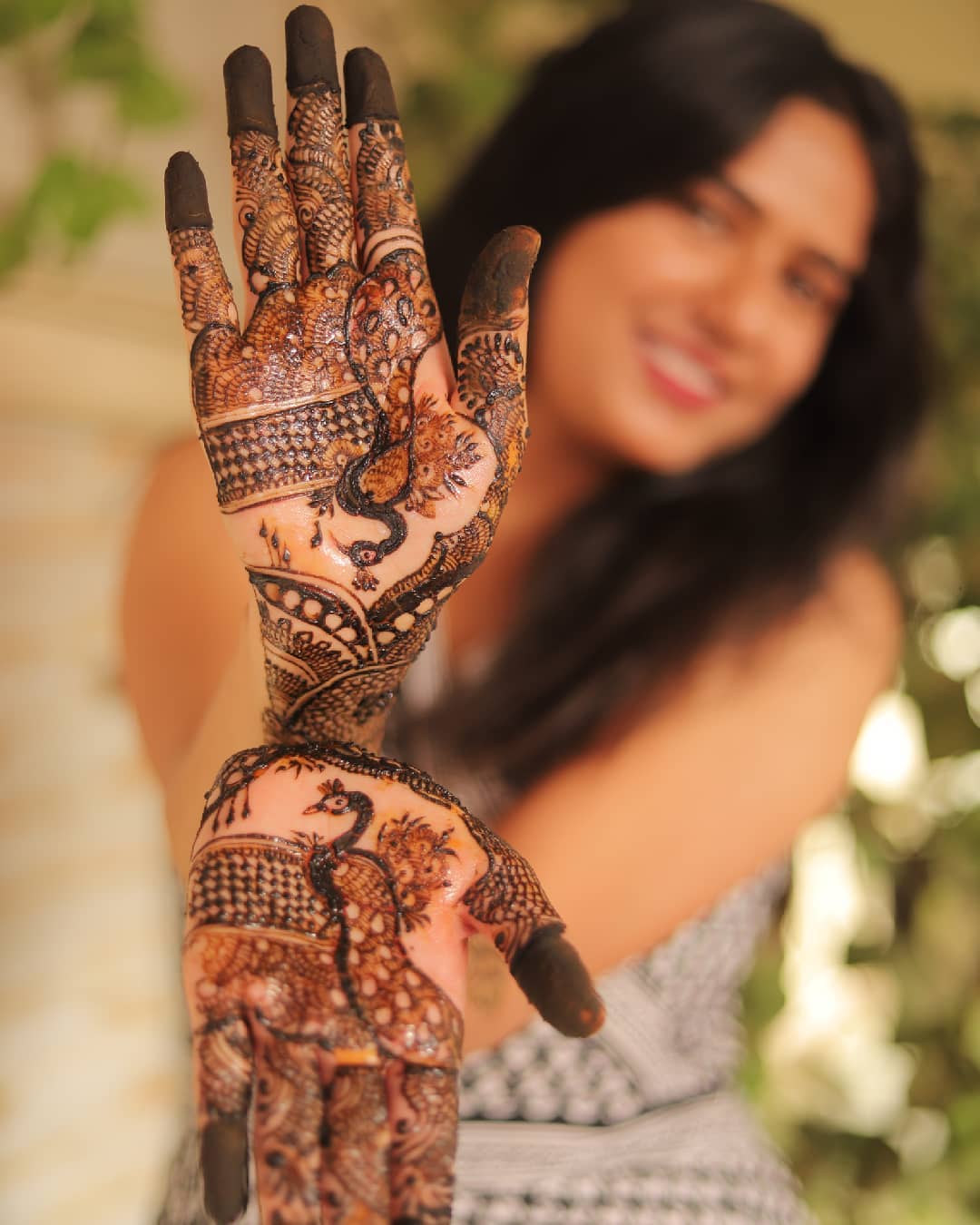 pose showcasing bridal mehndi with joined hands