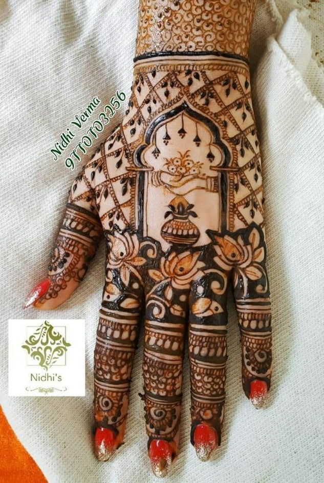 new back hand mehndi design for bride with kalash and lotus flower