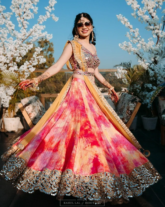 bride wearing colourful tie and die lehenga choli on haldi