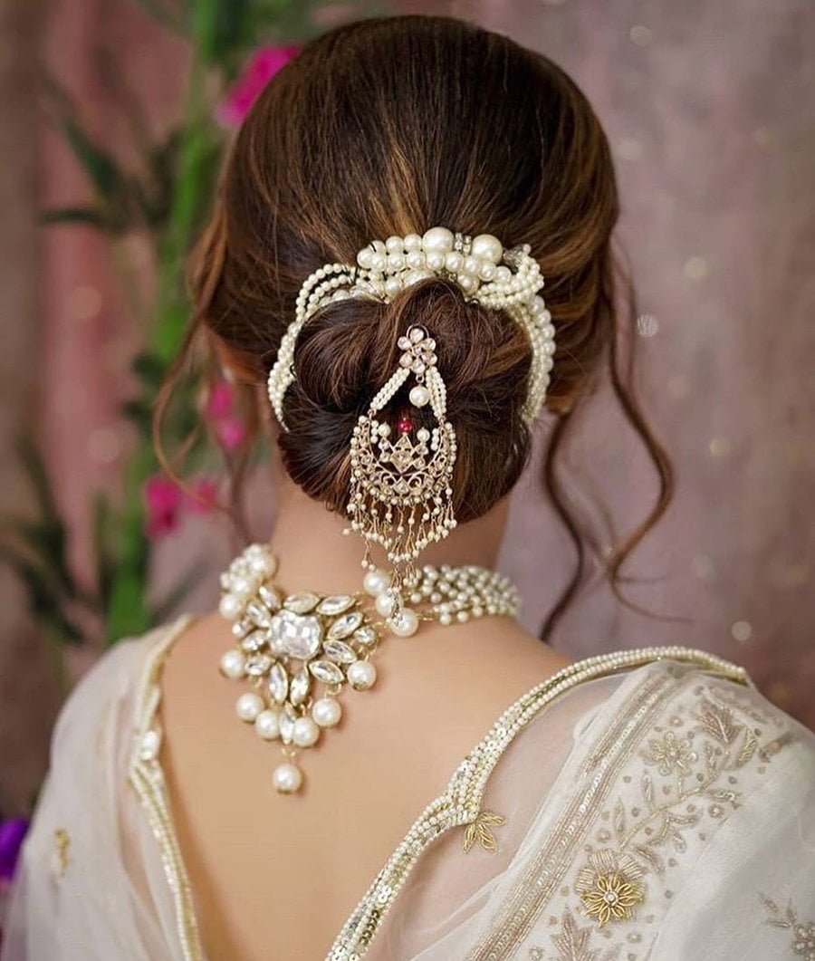 embellished bun hairstyle for reception with lehenga 