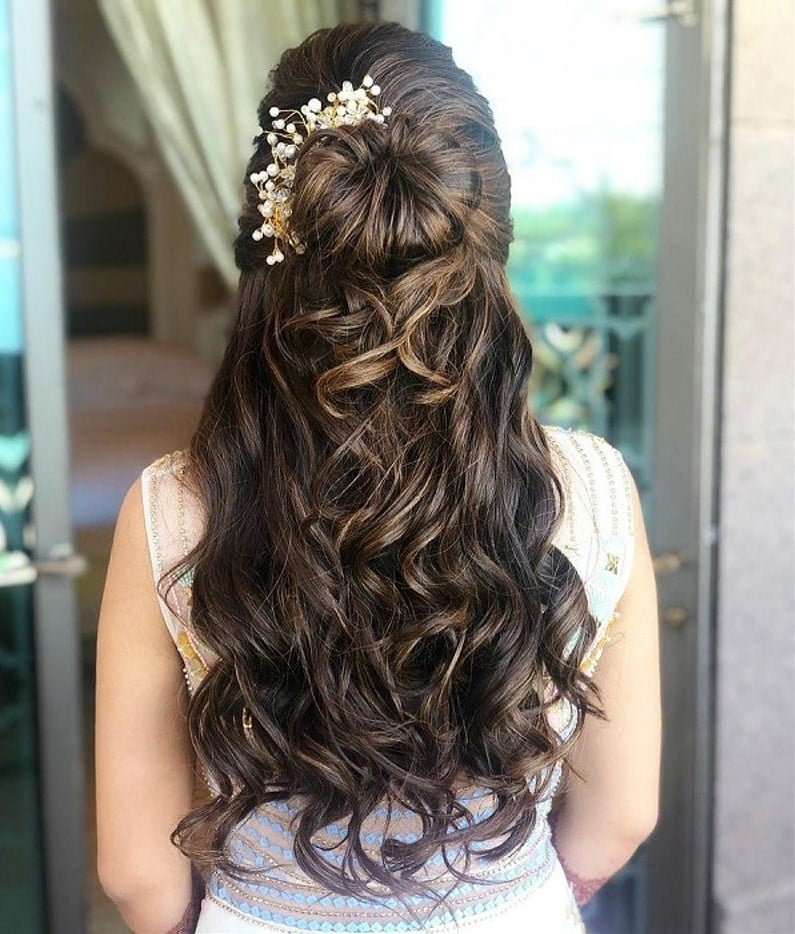 reception bridal hairstyle with gown featuring curls and donut bun