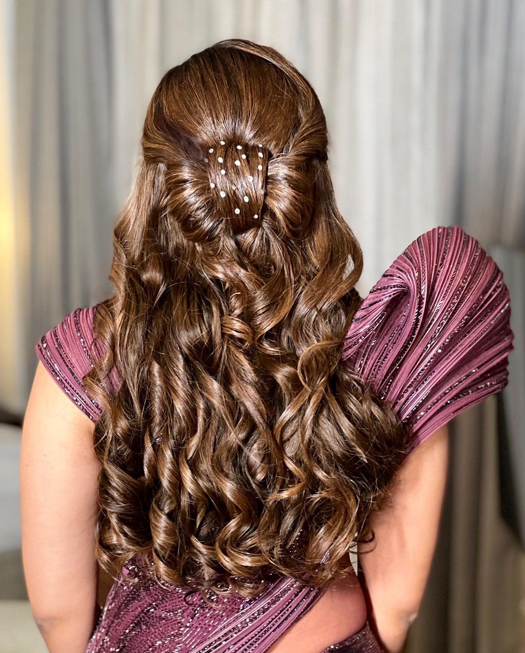 modern reception hairstyle for gown with curls and bow