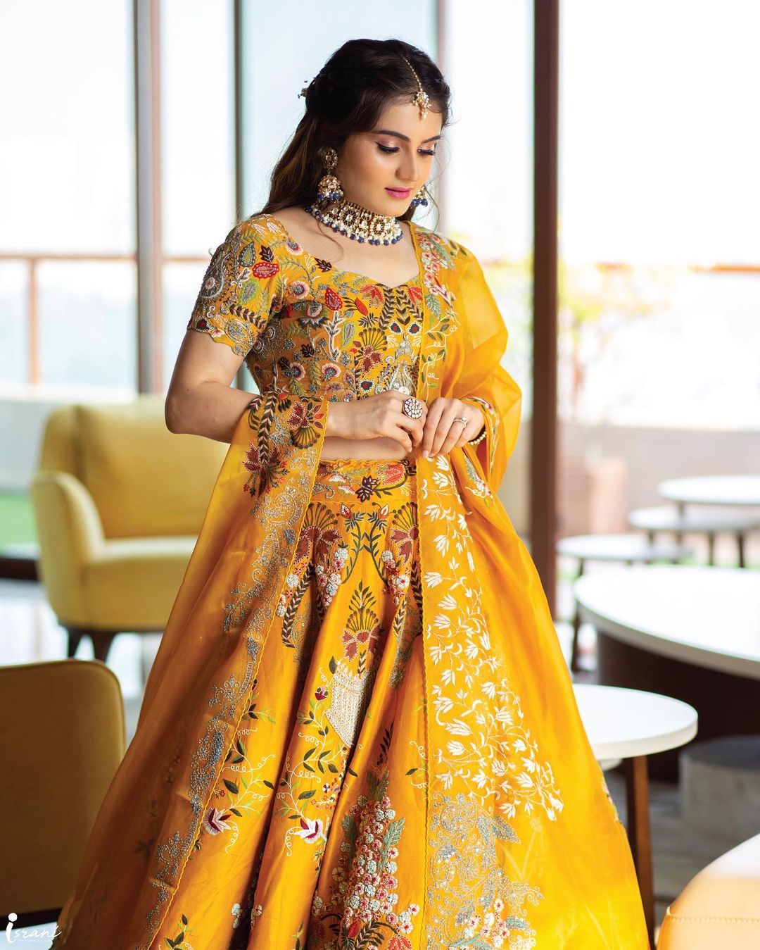 bride wearing yellow embroidered lehenga choli