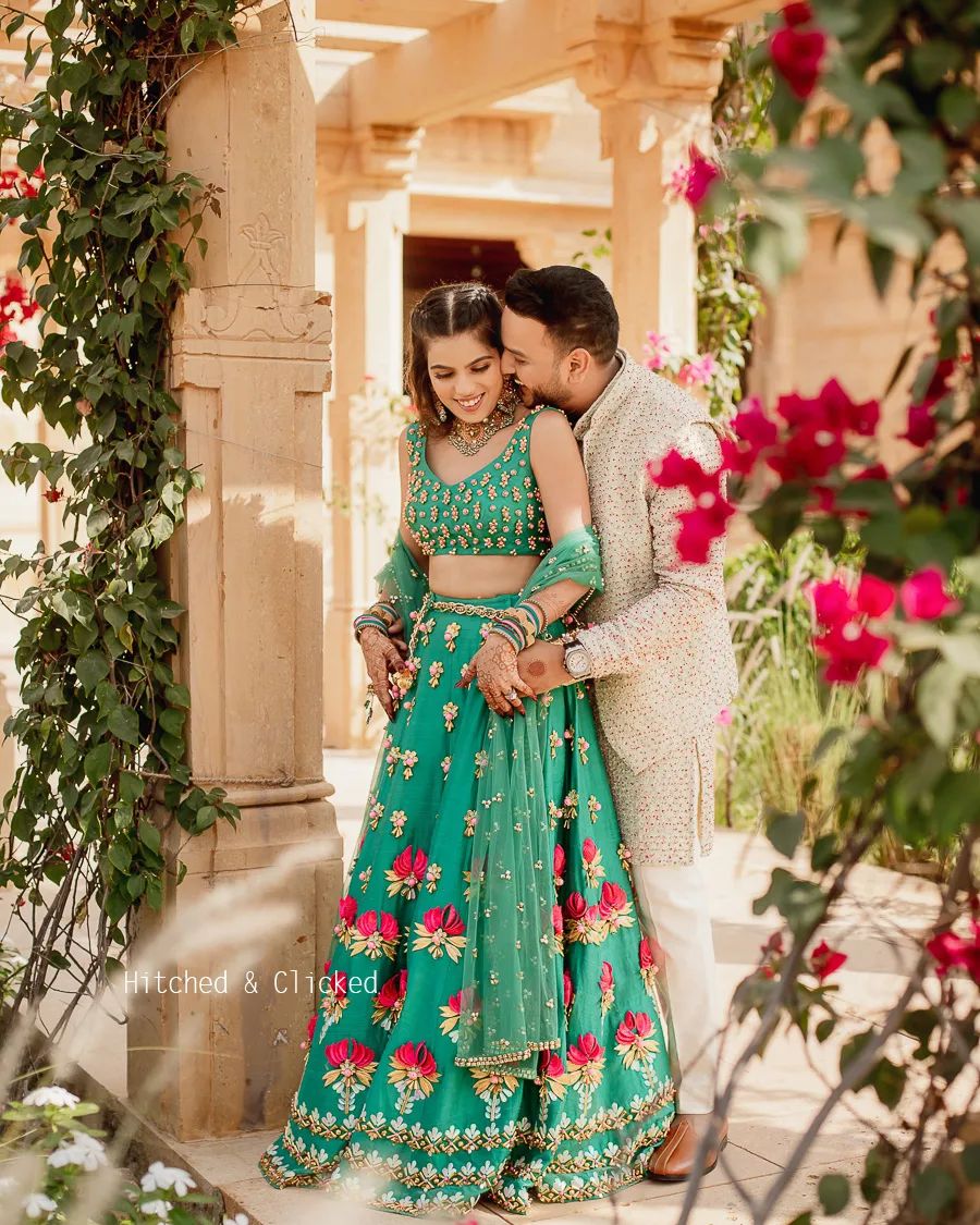 designer bridal mehndi dress in green with pink and golden floral motifs