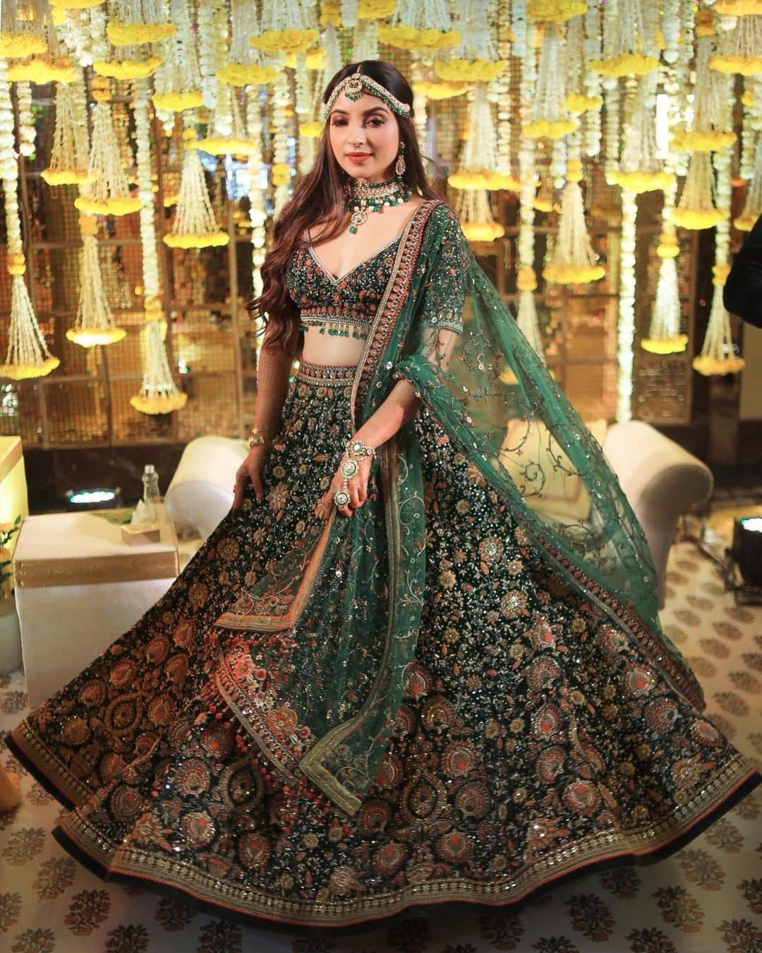 heavily embroidered mehndi dress for bride with floral motifs
