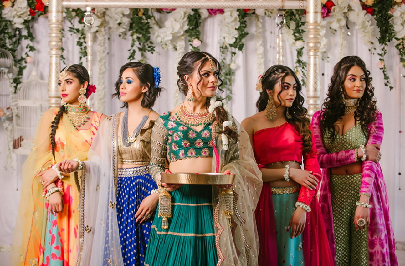 bride posing with bridesmaids for photoshoot