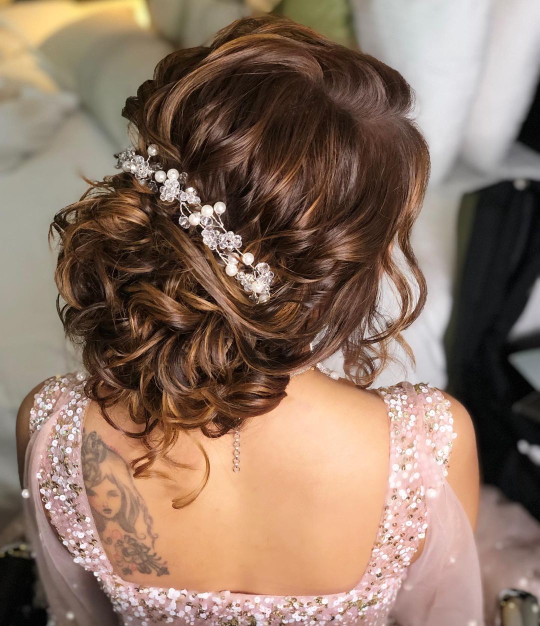 messy bun hairstyle for reception gown