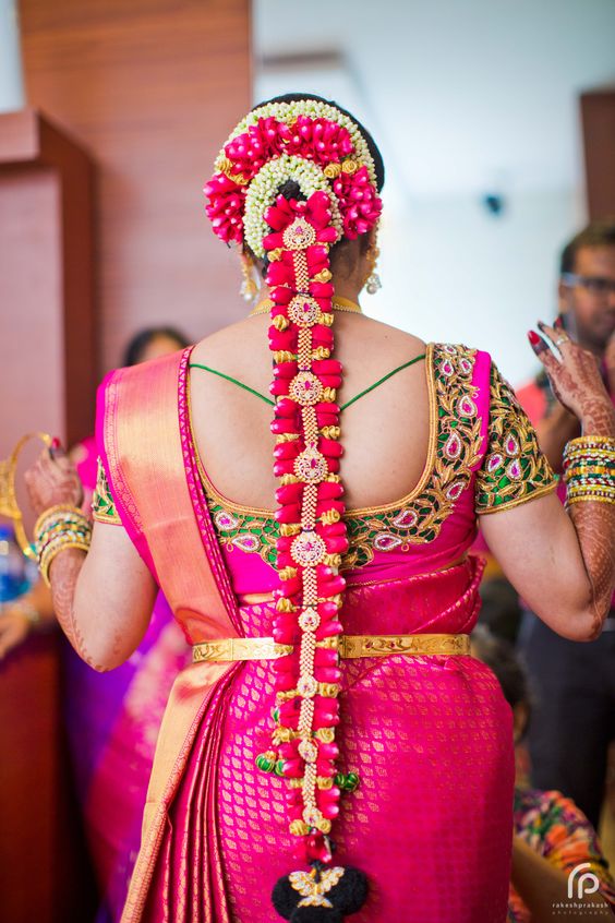 traditional hairstyle for south indian bride with flowers and billai hair accessory
