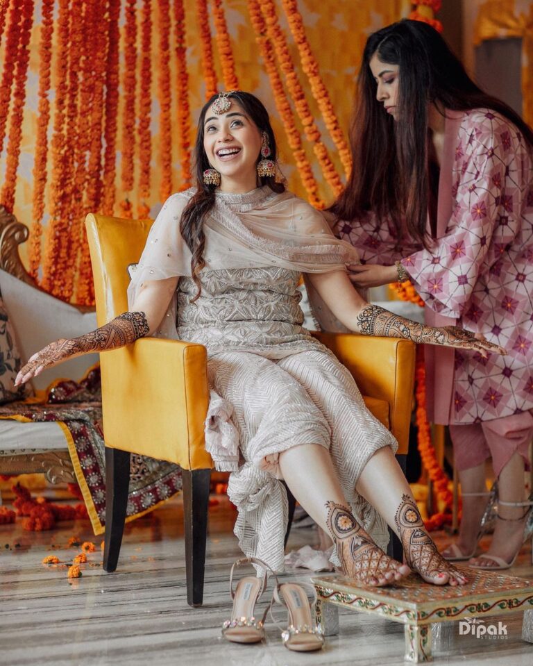 laughing bride getting ready pose for mehndi