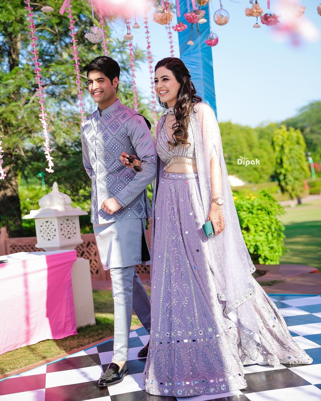 bride and groom in lavender engagement outfits
