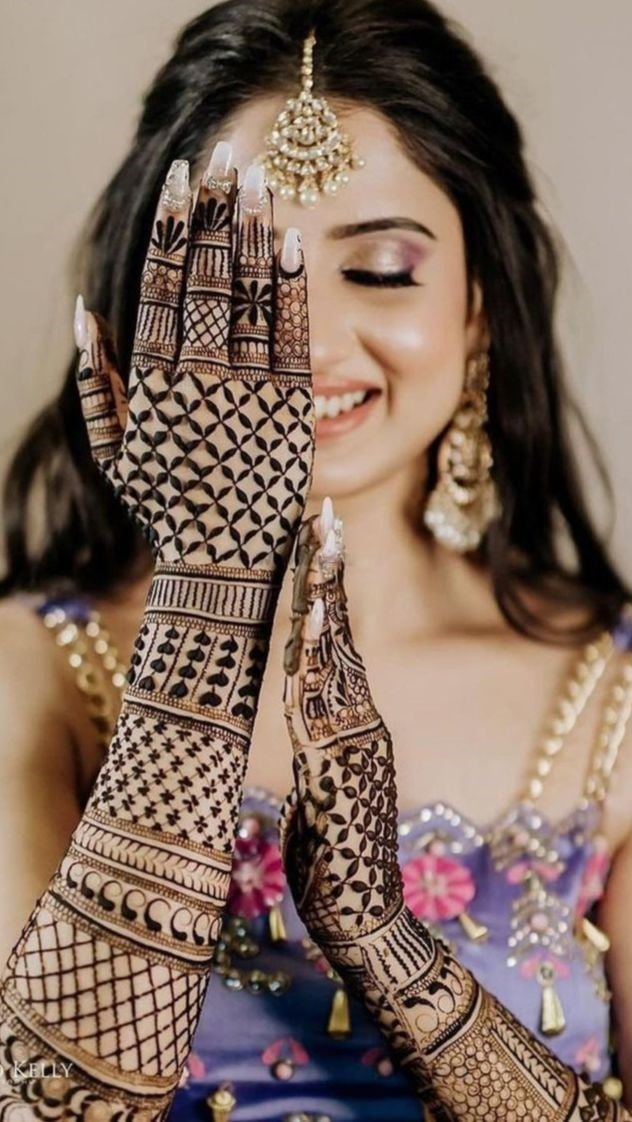 beautiful bride showing her back hand mehndi full design