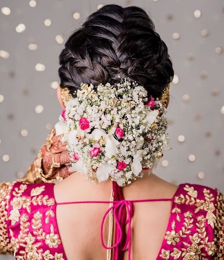 modern braided bun with flowers for reception