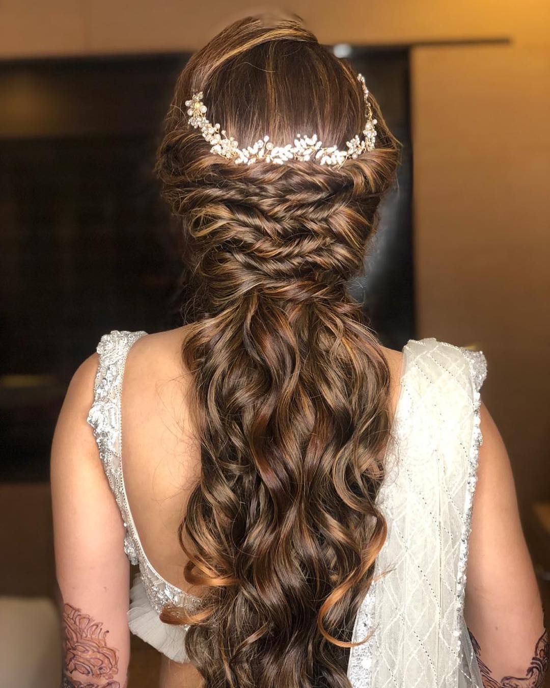 braided low ponytail wedding reception hairstyle for lehenga