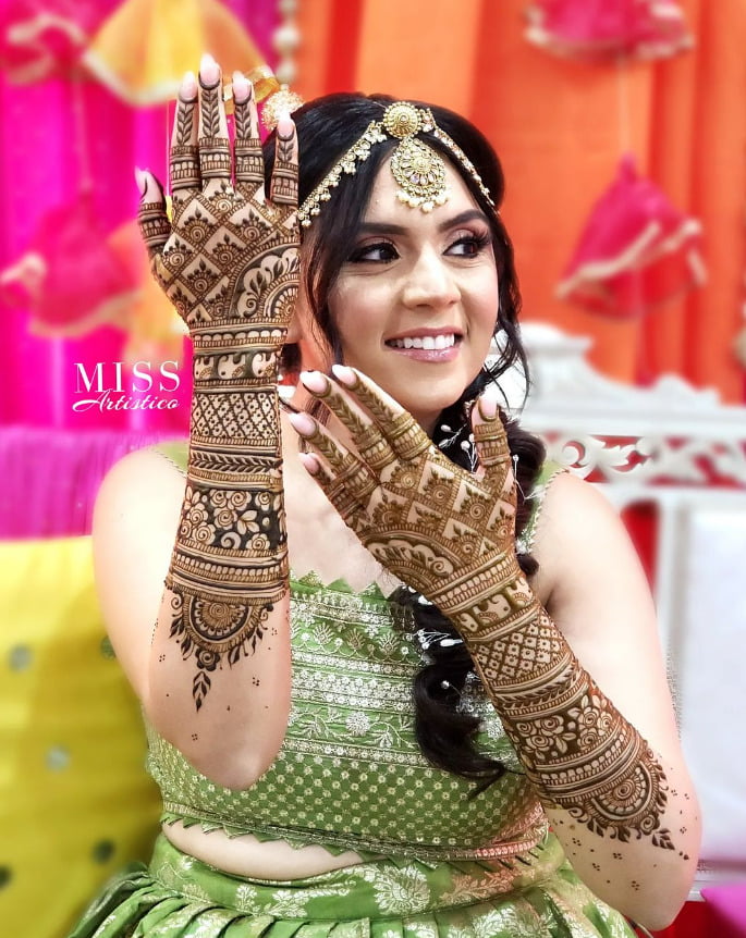 bride with her beautiful back hand mehndi design 