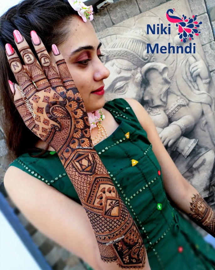 stylish and modern back hand mehndi design for bride with peacock