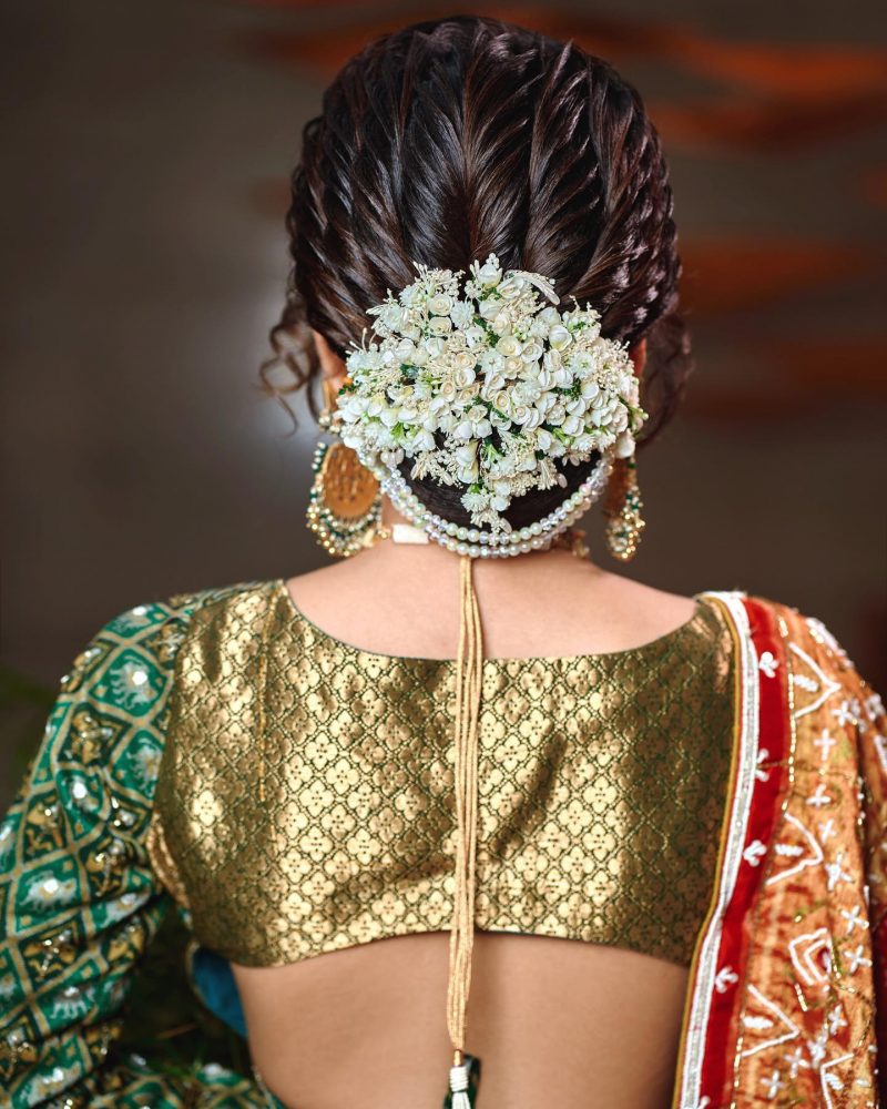 braided bun with gajra reception hairstyle for bride 