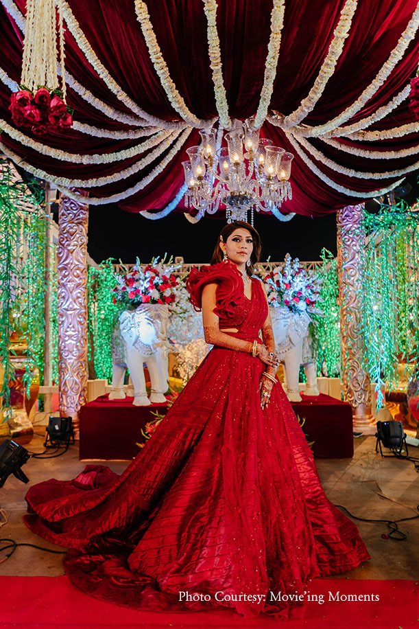 red lehenga with statement blouse and belt for reception