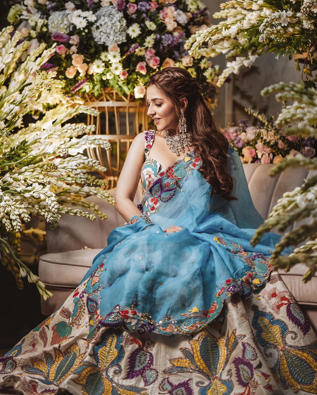 bride in colourful embroidered engagement lehenga dress