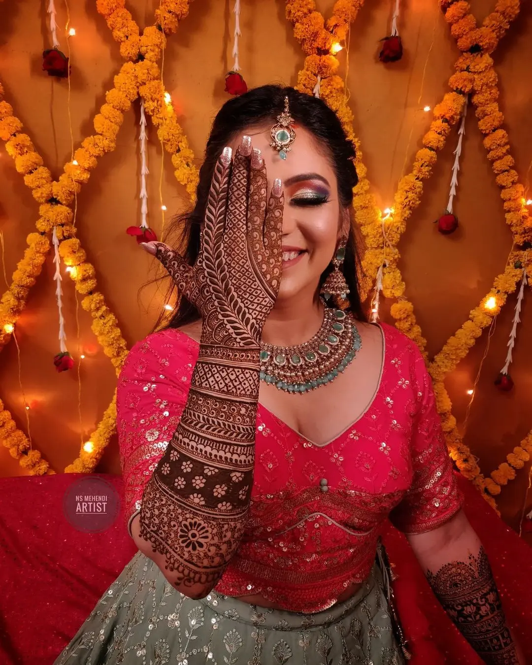 one hand on eye mehndi pose for bride 
