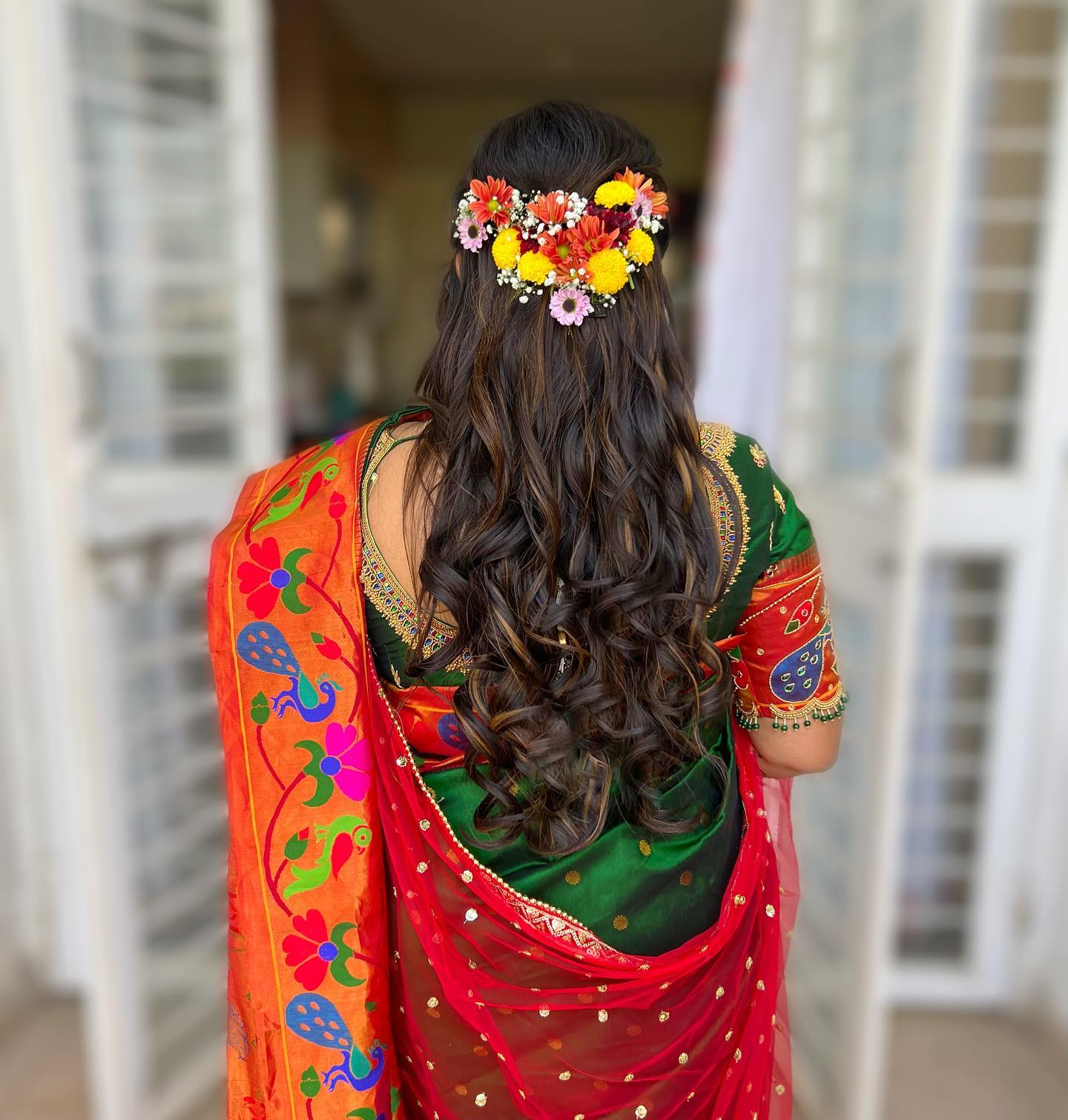 half tie curls with flowers hairdo for engagement in saree