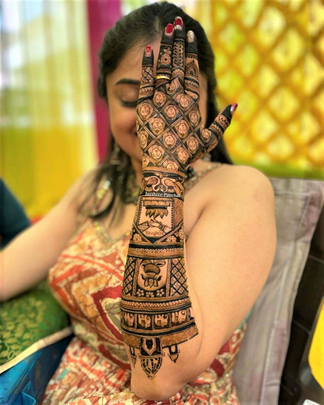 bridal back hand mehendi with elephants and palace