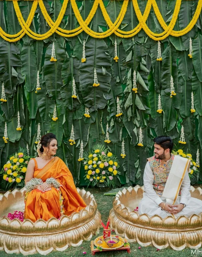 low cost background haldi ceremony decoration with banana leaf for bride and groom