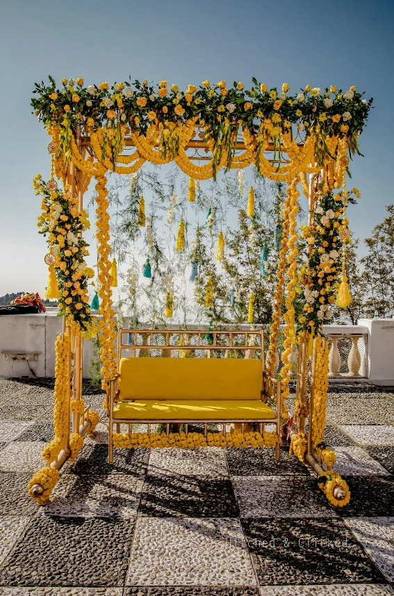 yellow flower and tassel jhula decoration for haldi