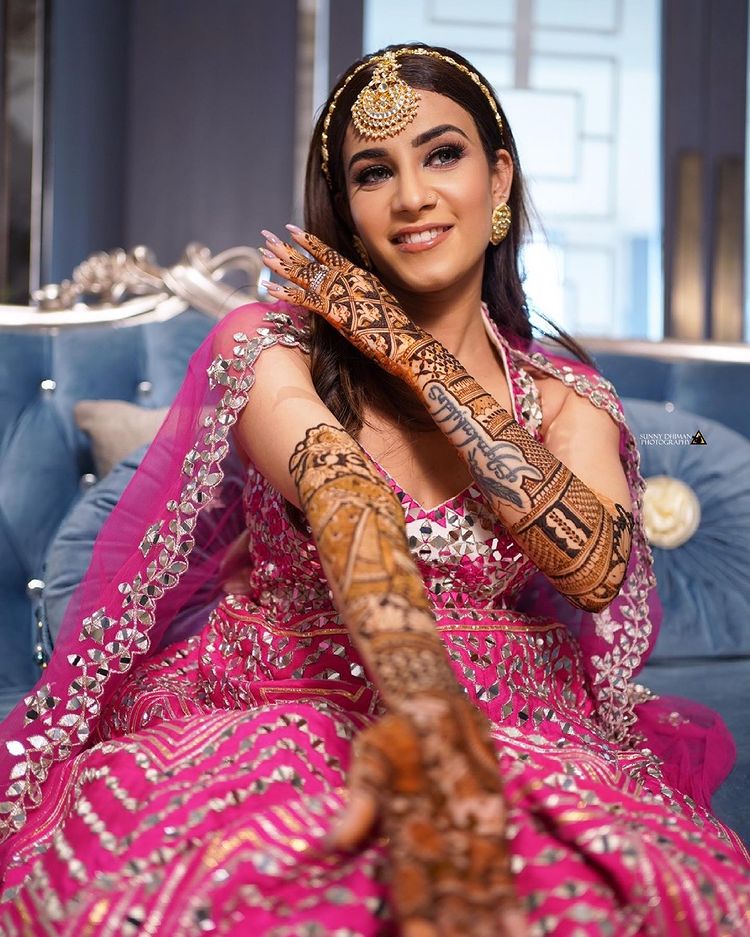bride showing her beautiful mehndi design