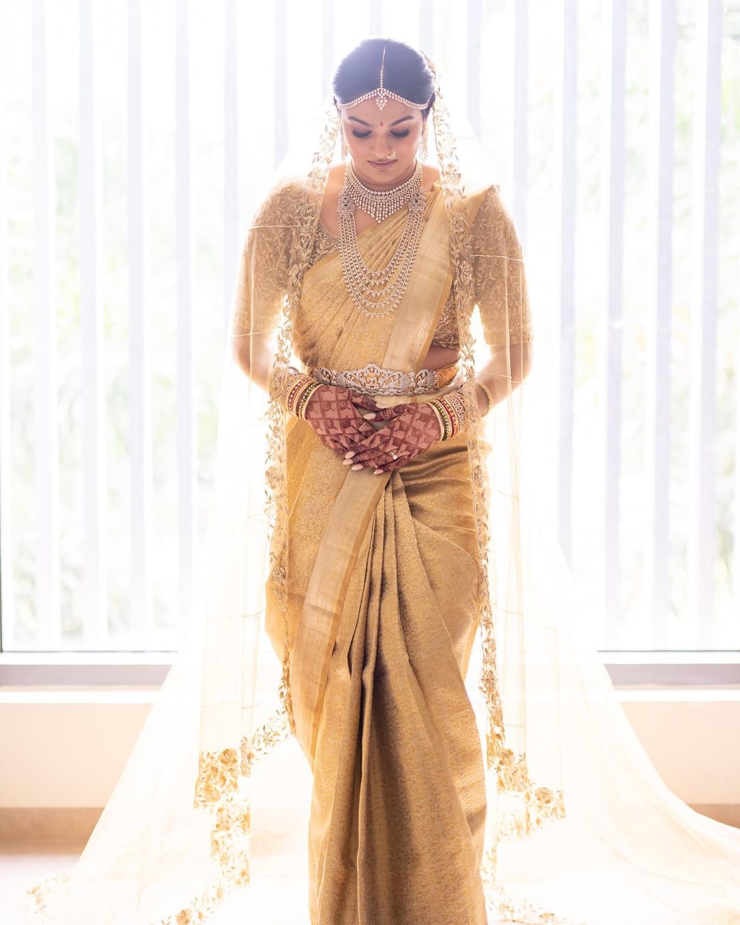 simple south indian bride in golden pattu silk saree with dupatta