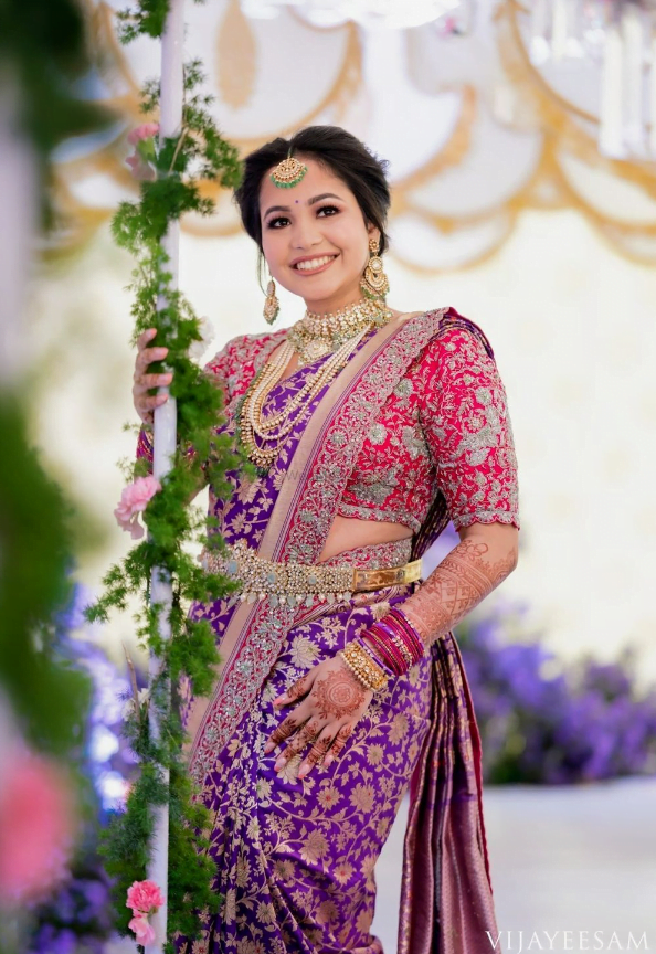 south indian bride in purple kanjeevaram saree and contrast blouse