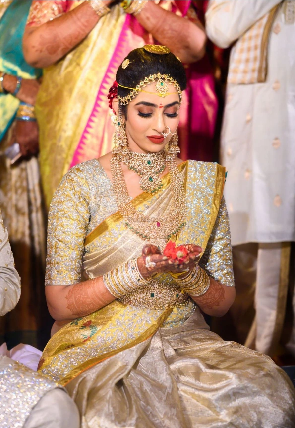 south indian bride wearing yellow and white kanjeevaram silk saree and diamond jewellery
