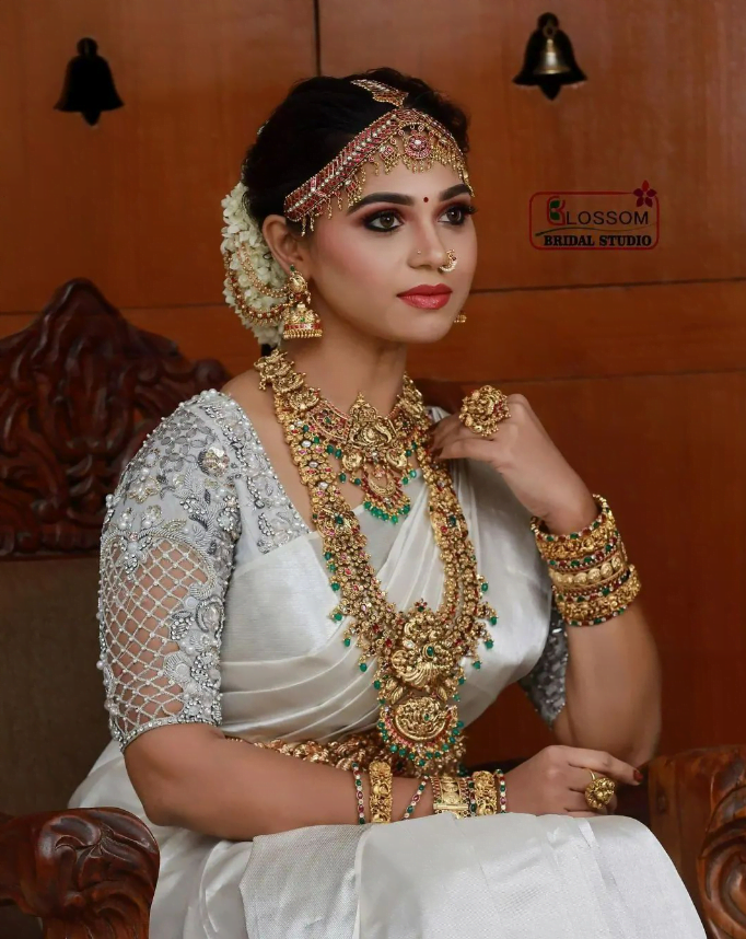 south bride wearing white saree and traditional and antique jewellery sets