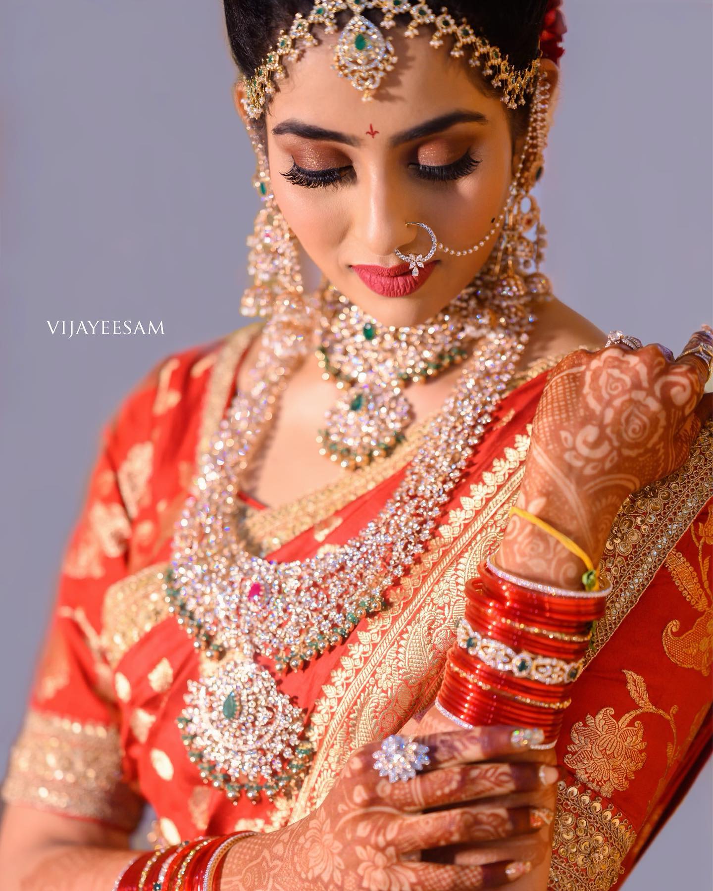 traditional wearing red silk saree and diamond jewellery