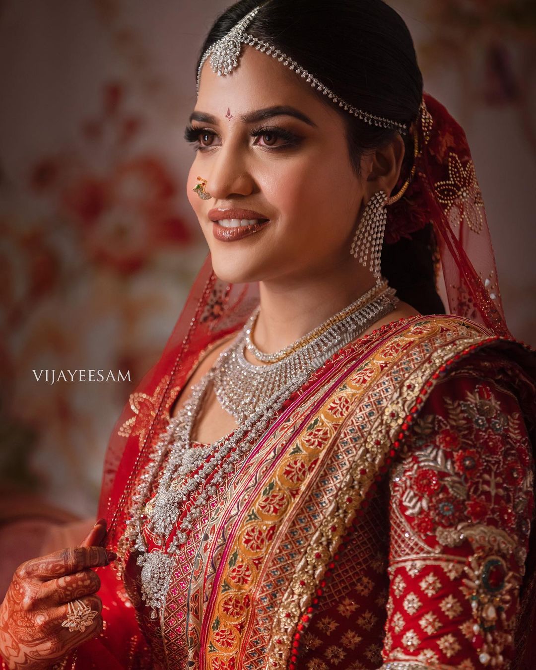 south indian bride wearing red silk saree with dupatta and diamond jewellery